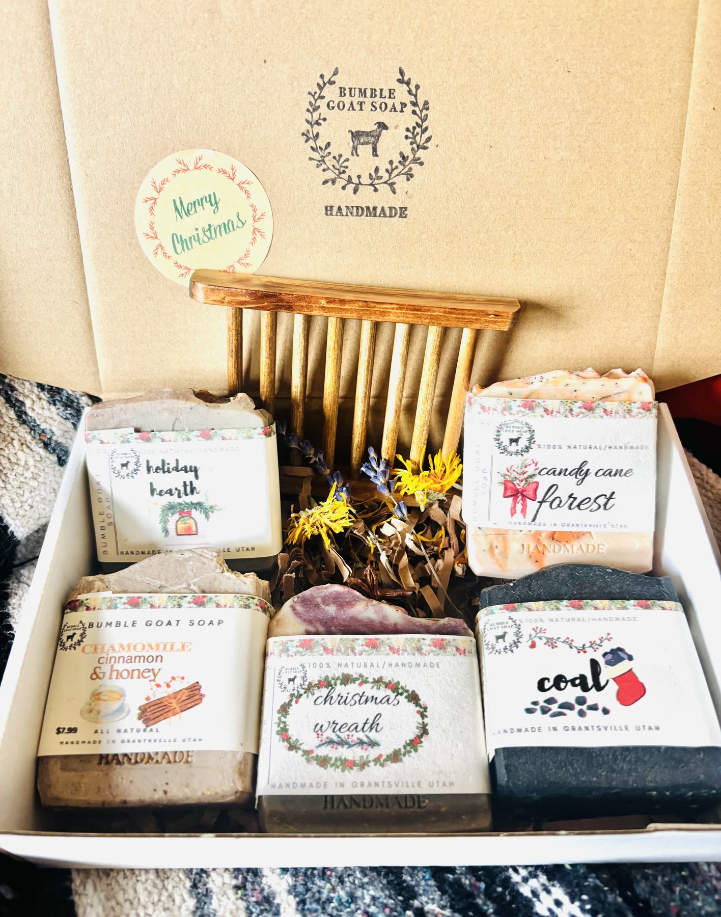 A holiday gift box of Bumble Goat soaps with a wood soap saver